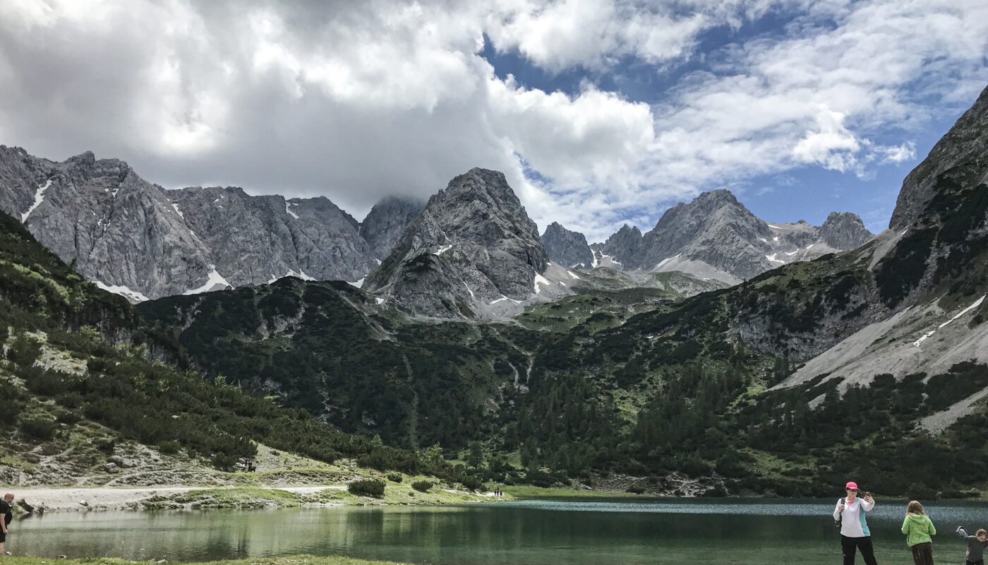 https://www.magnific.com/free-photo/wide-shot-tourists-near-lake-bottom-mountains-surrounded-with-trees-green-plants_7822595.htm#fromView=search&page=2&position=2&uuid=0746fd53-26d8-4abb-9102-da3ee724ce73&query=Why+Alpbach+Is+an+Ideal+Base+for+Exploring+the+Tyrolean+Alps